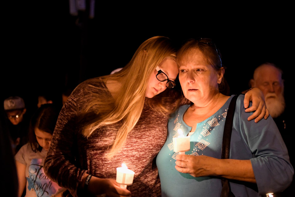 Local residents embrace during a candlelight vigil for victims of a mass shooting in a church in Sutherland Springs, Texas. Local residents embrace during a candlelight vigil for victims of a mass shooting in a church in Sutherland Springs, Texas.